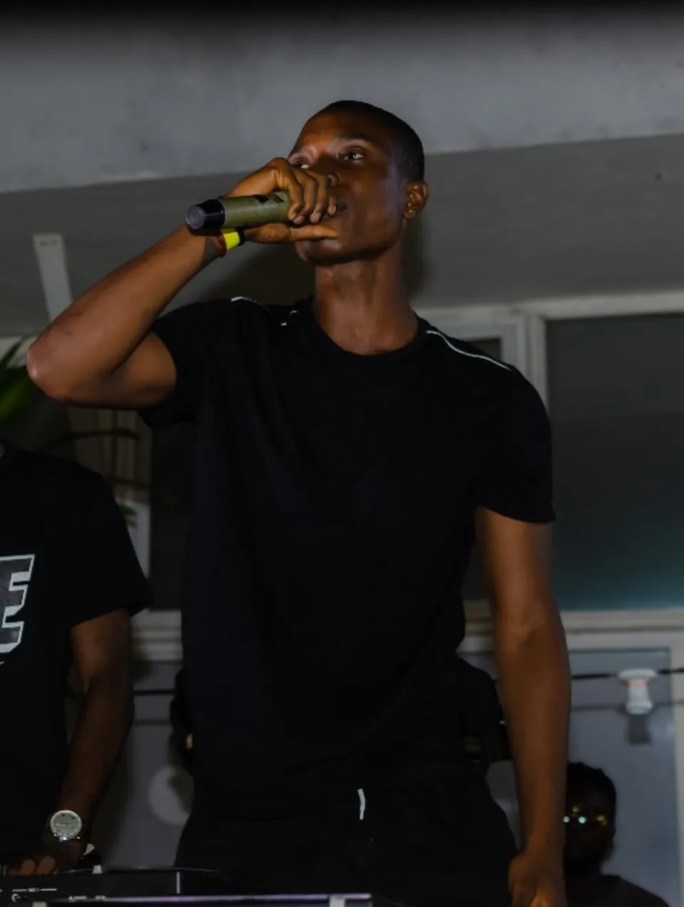 A performer holding a microphone during The Hangawt