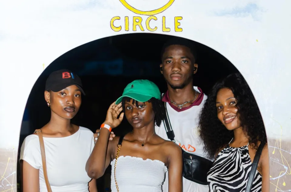 Four friends together beneath the Circle photo arch