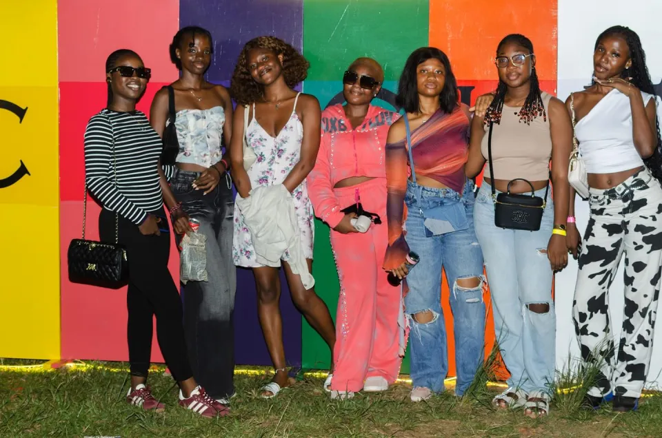 A group of friends posing against the colourful Circles photo wall