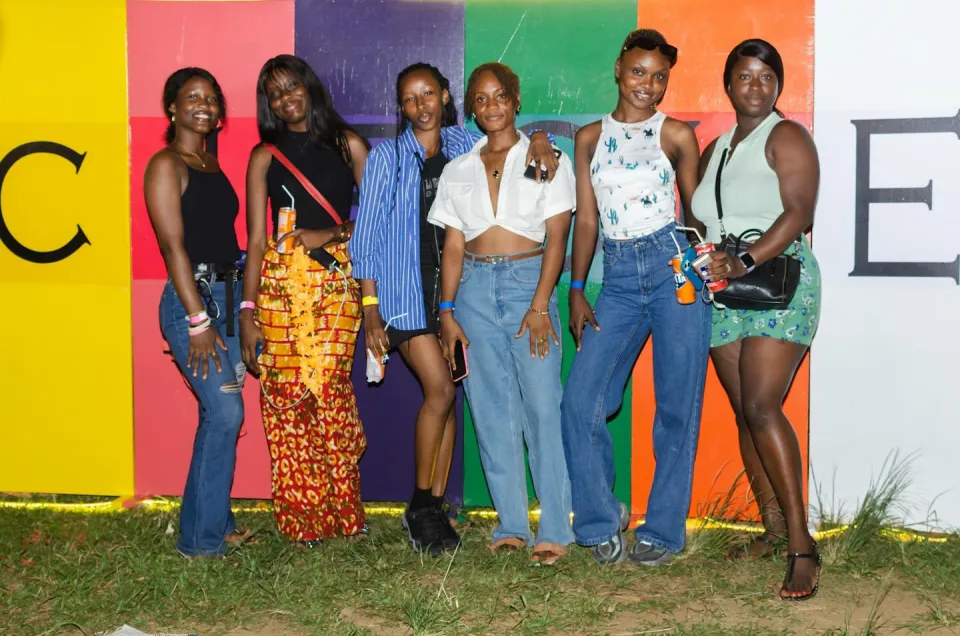 A group of friends smiling at the Circles photo wall