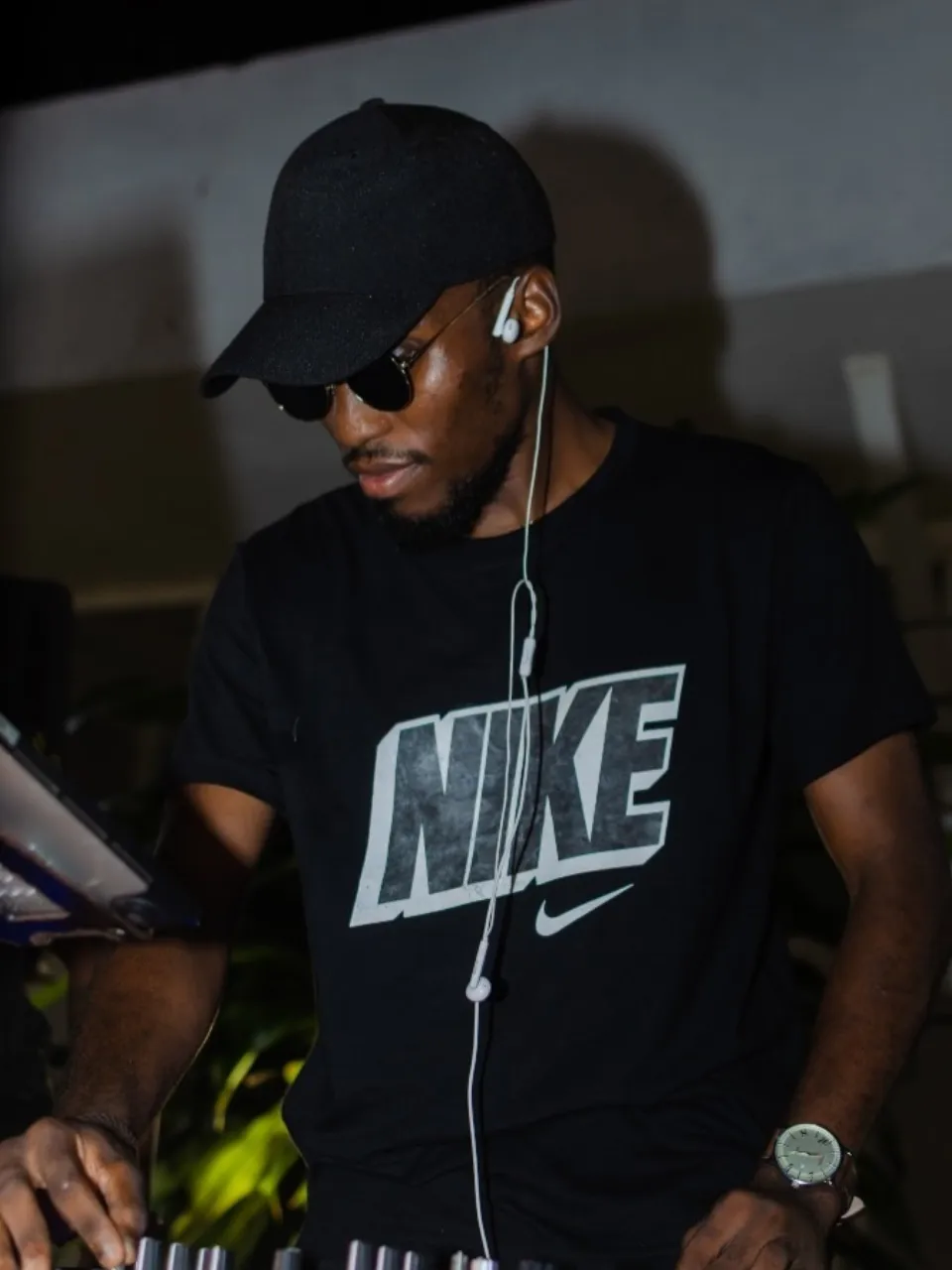 A DJ wearing headphones and a black shirt at The Hangawt