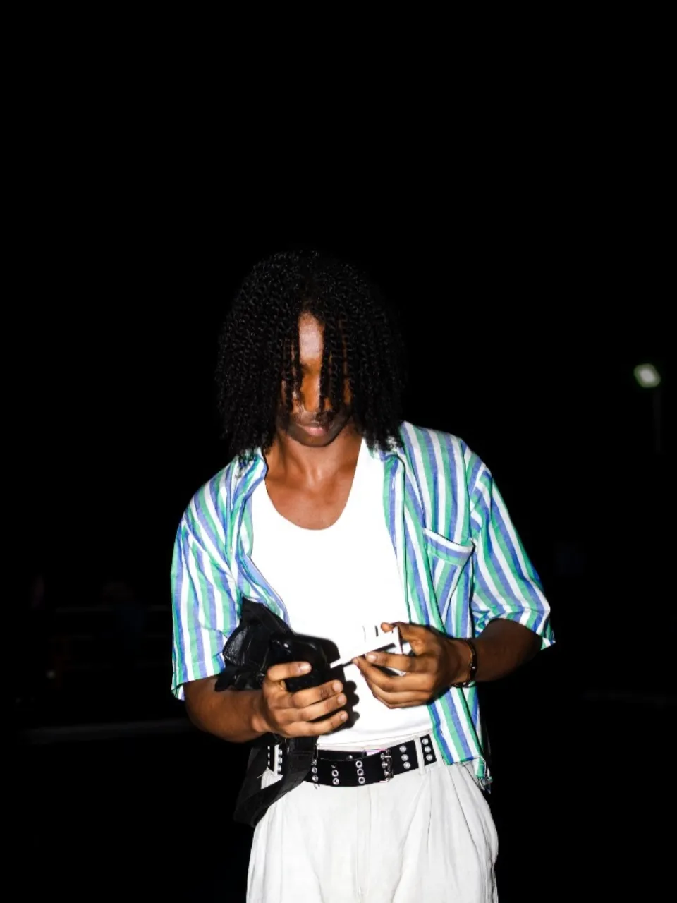 A guest in a striped shirt and white trousers at The Hangawt