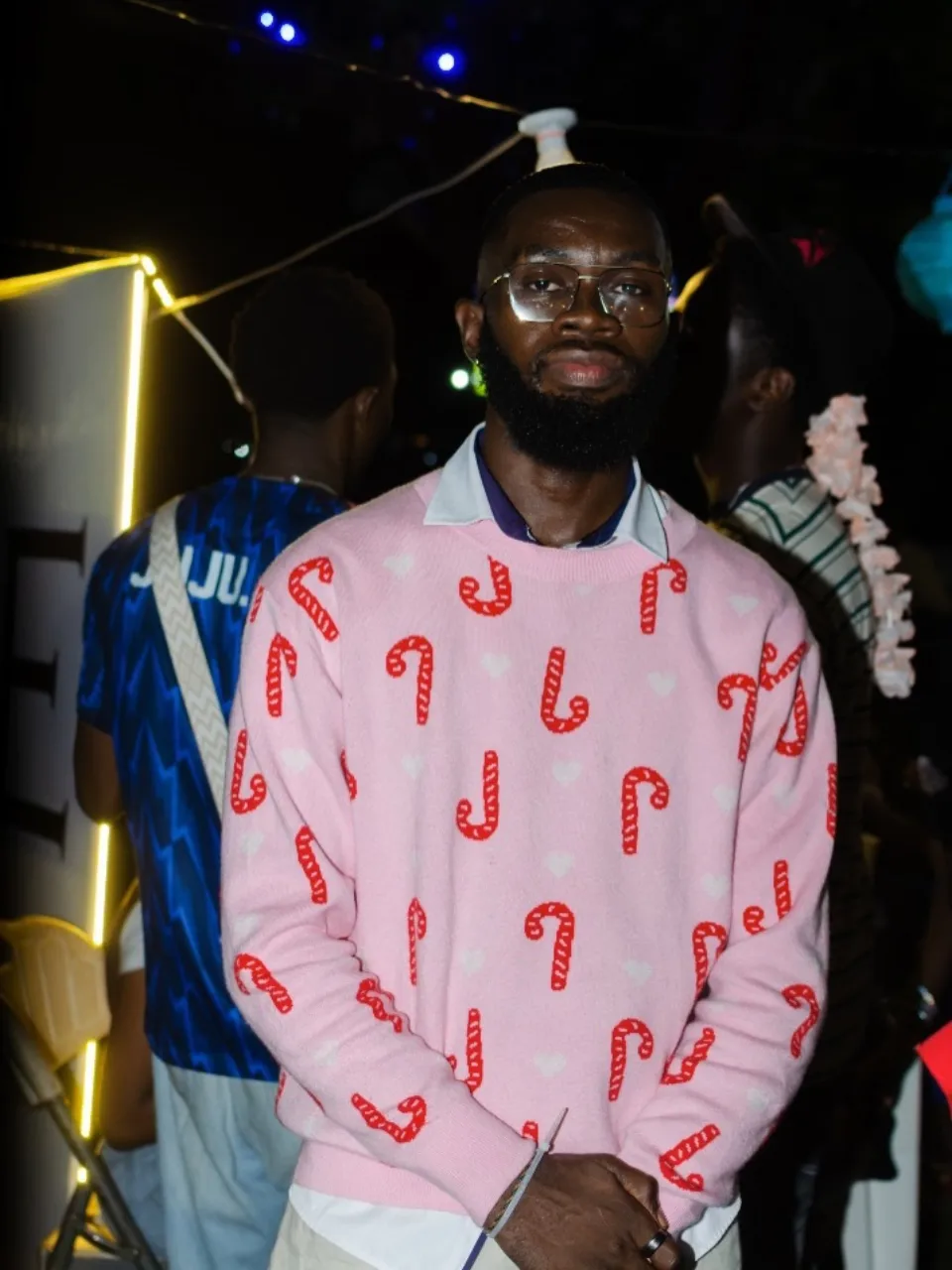 A guest in a pink patterned shirt and cap at The Hangawt