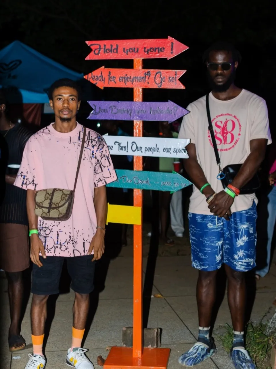 Two friends standing beside the Hangawt signpost